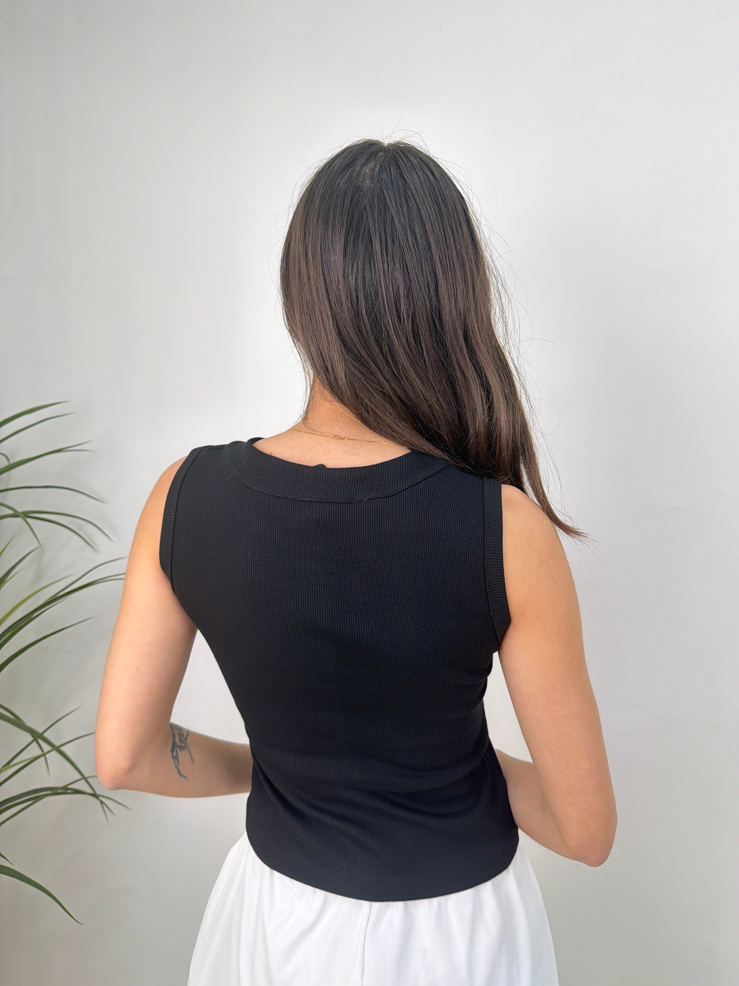 Top a costine smanicato con bottoni frontali