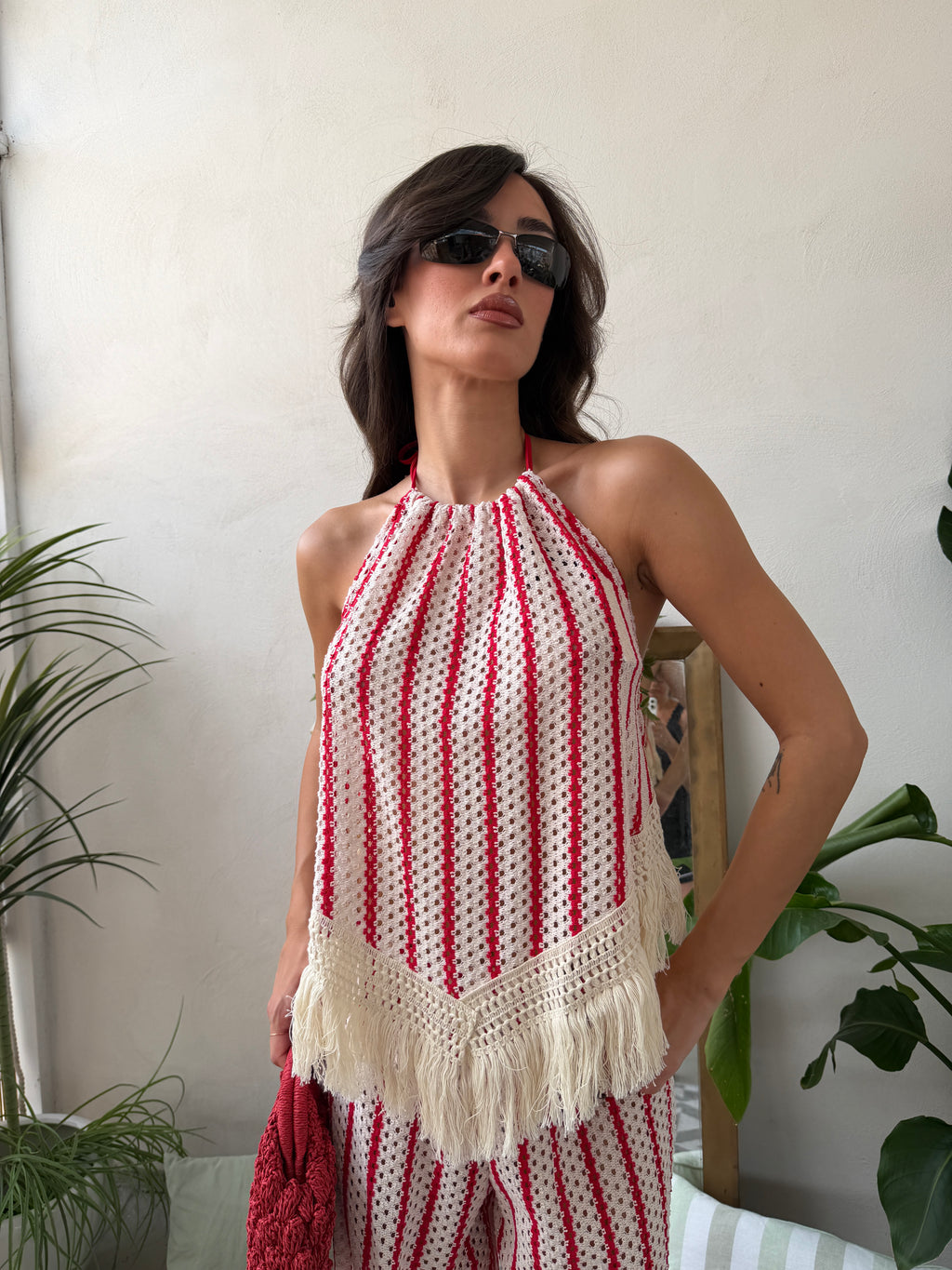 Coordinato in maglia traforata con top a e pantalone palazzo con frange